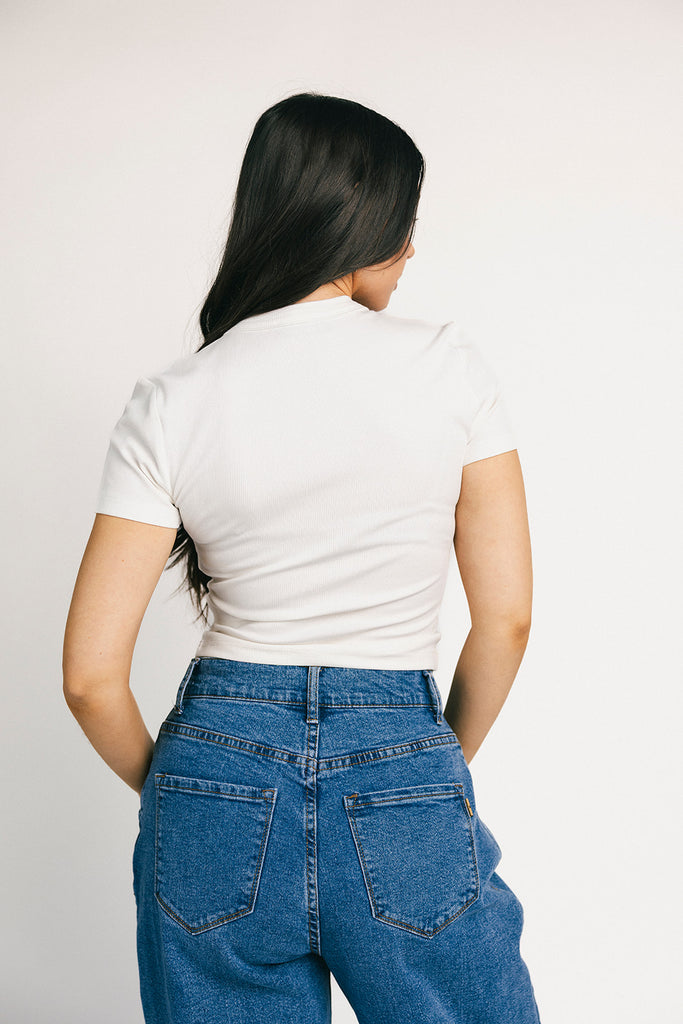 a classic plain white baby tee with a slightly cropped silhouette. the perfect fitted white t-shirt for everyday wear + casual outfit styling.

