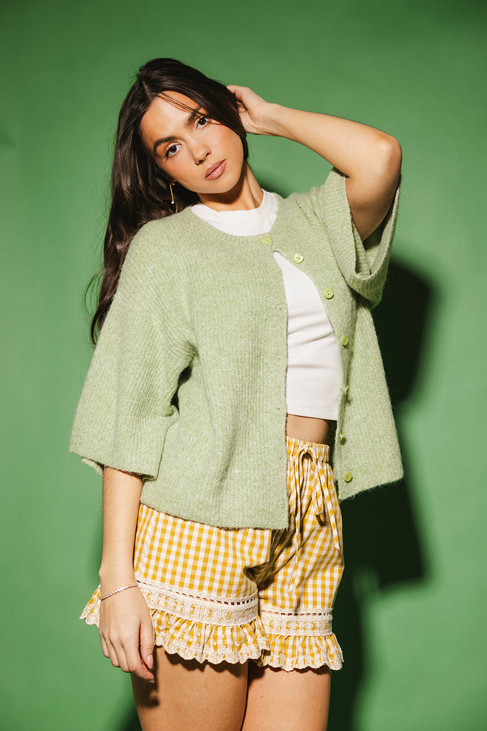 light green short sleeve cardigan with a slouchy, relaxed fit. perfect for casual outfits + lightweight layering.
