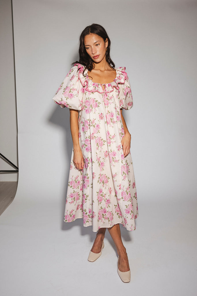 a pink floral puff sleeve dress with a ruffle neckline. the perfect vintage-inspired dress for baby showers, family pictures, + special occasions.
