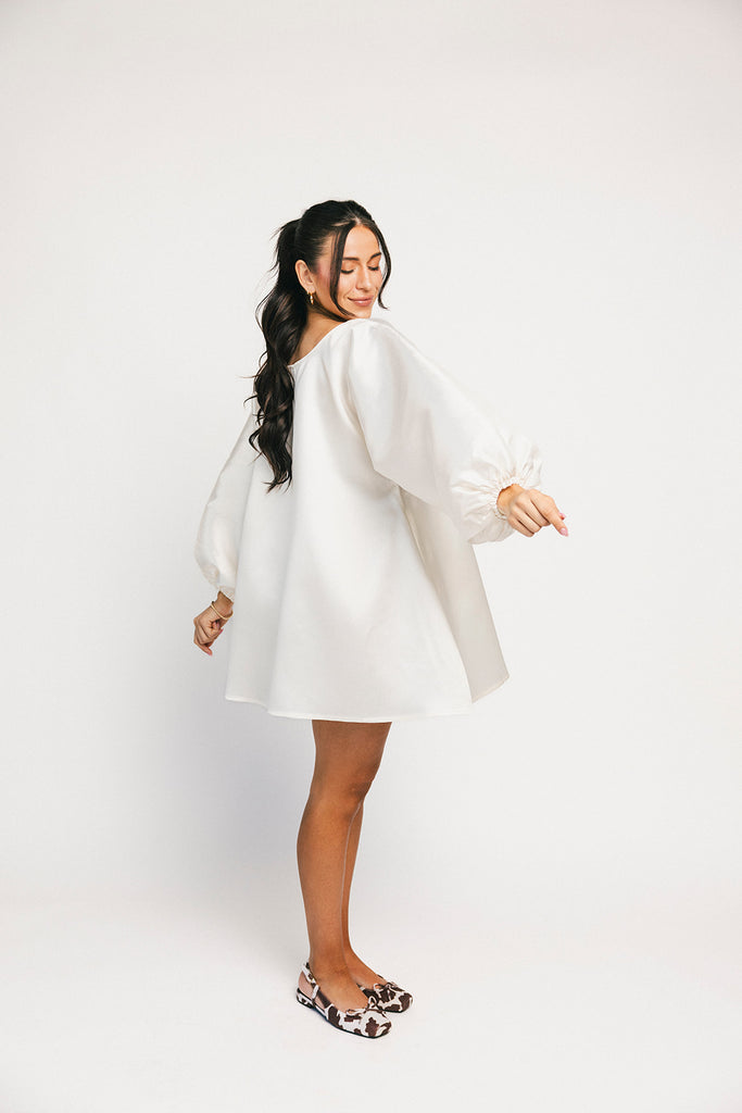 a white satin mini dress with a vintage-inspired silhouette + long balloon sleeves. the perfect little white dress for graduations, bridal showers, + fancy dinner dates.
