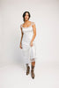 a white satin midi dress with lace detailing + a fitted silhouette. the perfect short sleeve occasion dress for weddings, bridal showers, + dinner parties.
