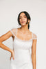 a white satin midi dress with lace detailing + a fitted silhouette. the perfect short sleeve occasion dress for weddings, bridal showers, + dinner parties.
