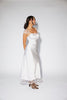 a white satin midi dress with lace detailing + a fitted silhouette. the perfect short sleeve occasion dress for weddings, bridal showers, + dinner parties.
