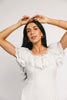 a white vintage-inspired midi dress with a lace ruffle neckline + bow detail. the perfect white dress for bridal showers, rehearsal dinners, + any special occasion.
