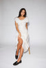 a white vintage-inspired midi dress with a lace ruffle neckline + bow detail. the perfect white dress for bridal showers, rehearsal dinners, + any special occasion.
