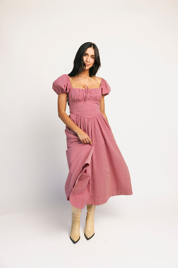 vintage-inspired puff sleeve dress with a square neckline. the perfect red gingham puff sleeve dress for rodeos, family pictures,+ semi-casual occasions.
