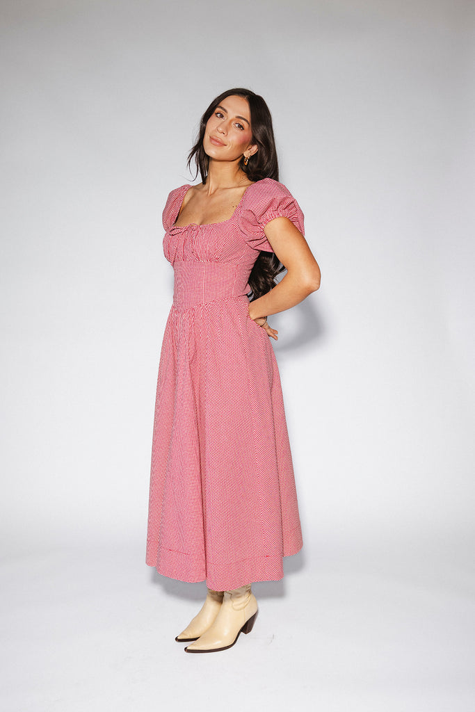 vintage-inspired puff sleeve dress with a square neckline. the perfect red gingham puff sleeve dress for rodeos, family pictures,+ semi-casual occasions.
