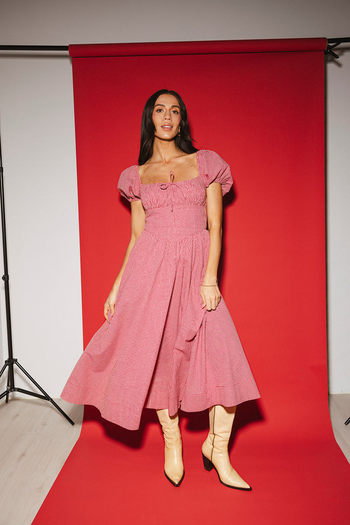 vintage-inspired puff sleeve dress with a square neckline. the perfect red gingham puff sleeve dress for rodeos, family pictures,+ semi-casual occasions.
