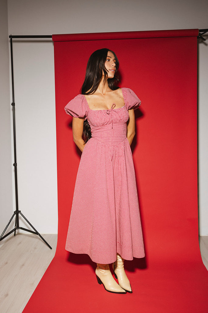 vintage-inspired puff sleeve dress with a square neckline. the perfect red gingham puff sleeve dress for rodeos, family pictures,+ semi-casual occasions.
