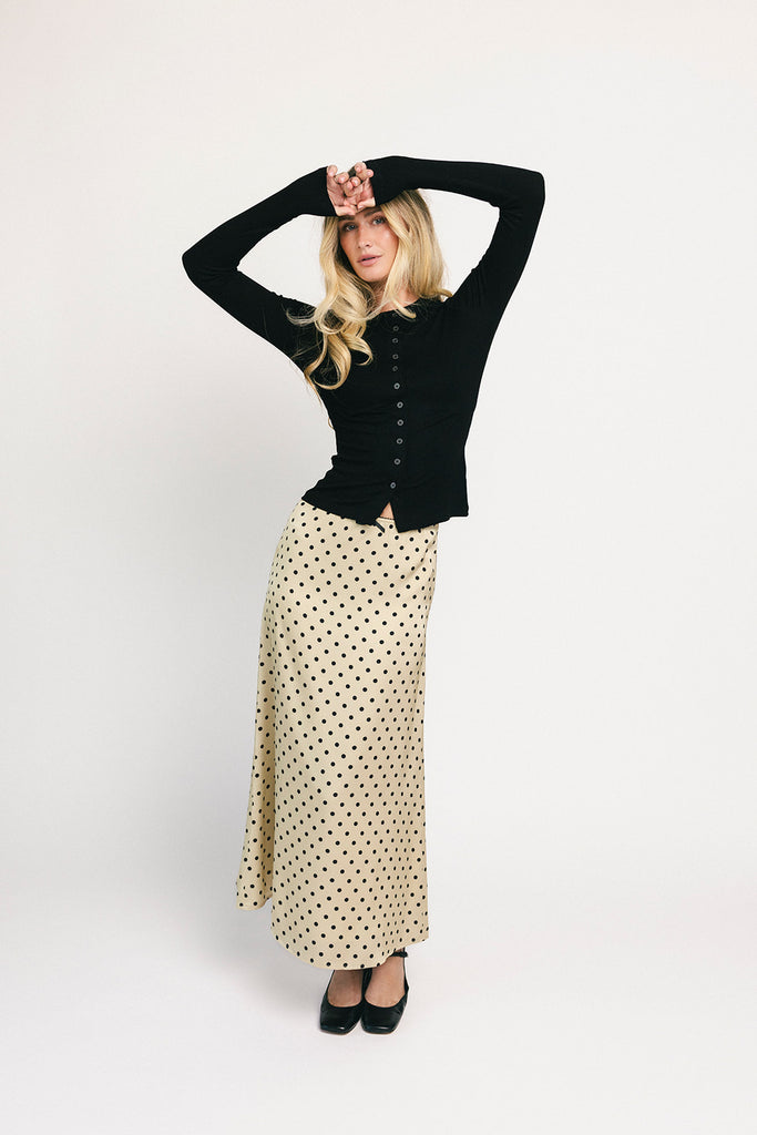 a vintage-inspired polka dot skirt with a dainty bow detail. the perfect slip skirt to dress up or down for any occasion. 
