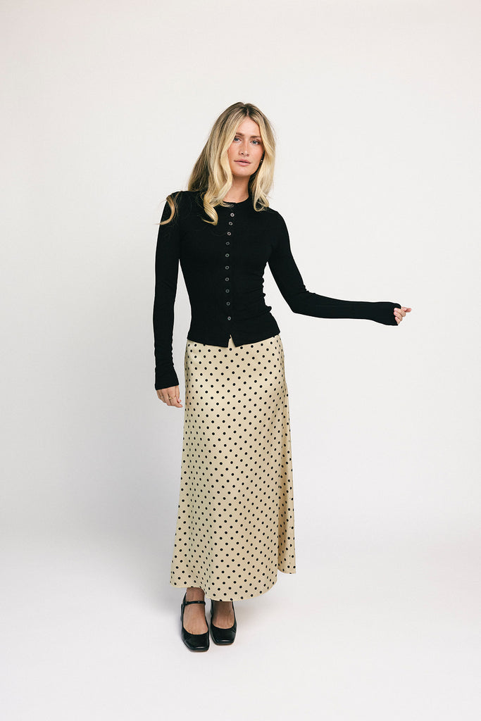 a vintage-inspired polka dot skirt with a dainty bow detail. the perfect slip skirt to dress up or down for any occasion. 

