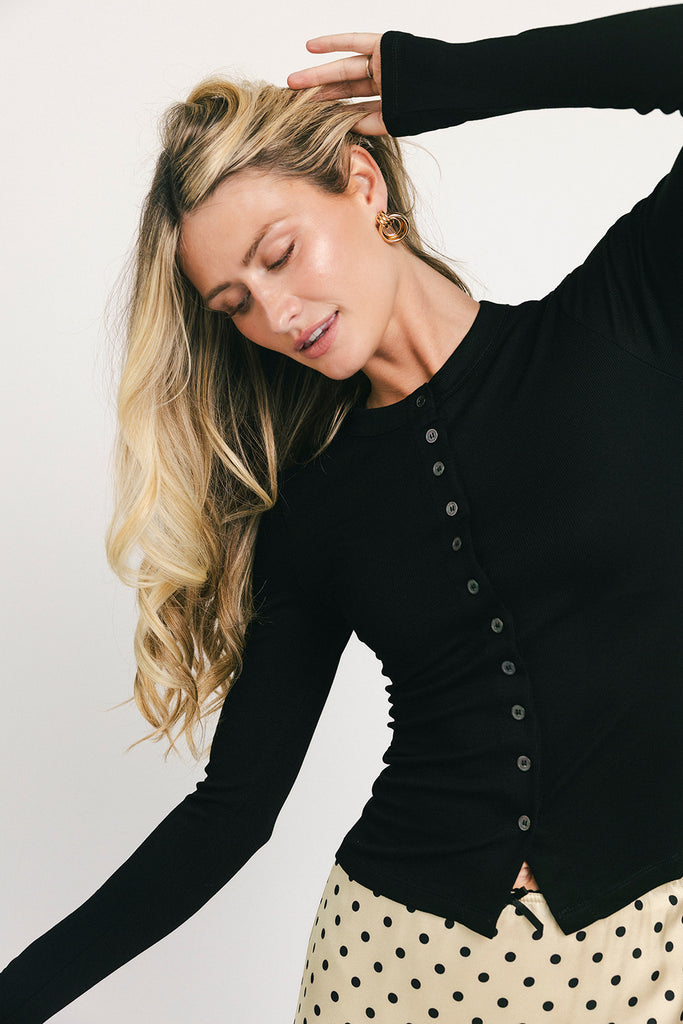 a stretchy black cardigan with a fitted silhouette. the perfect elevated basic for everyday wear + casual outfit styling.
