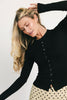 a stretchy black cardigan with a fitted silhouette. the perfect elevated basic for everyday wear + casual outfit styling.
