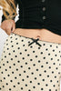 a vintage-inspired polka dot skirt with a dainty bow detail. the perfect slip skirt to dress up or down for any occasion. 
