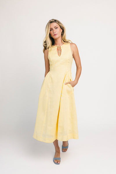 a classic yellow midi dress with a fitted bodice + a v waistline. the perfect vintage-inspired yellow dress for weddings, bridal showers, + garden parties.
