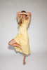 a classic yellow midi dress with a fitted bodice + a v waistline. the perfect vintage-inspired yellow dress for weddings, bridal showers, + garden parties.
