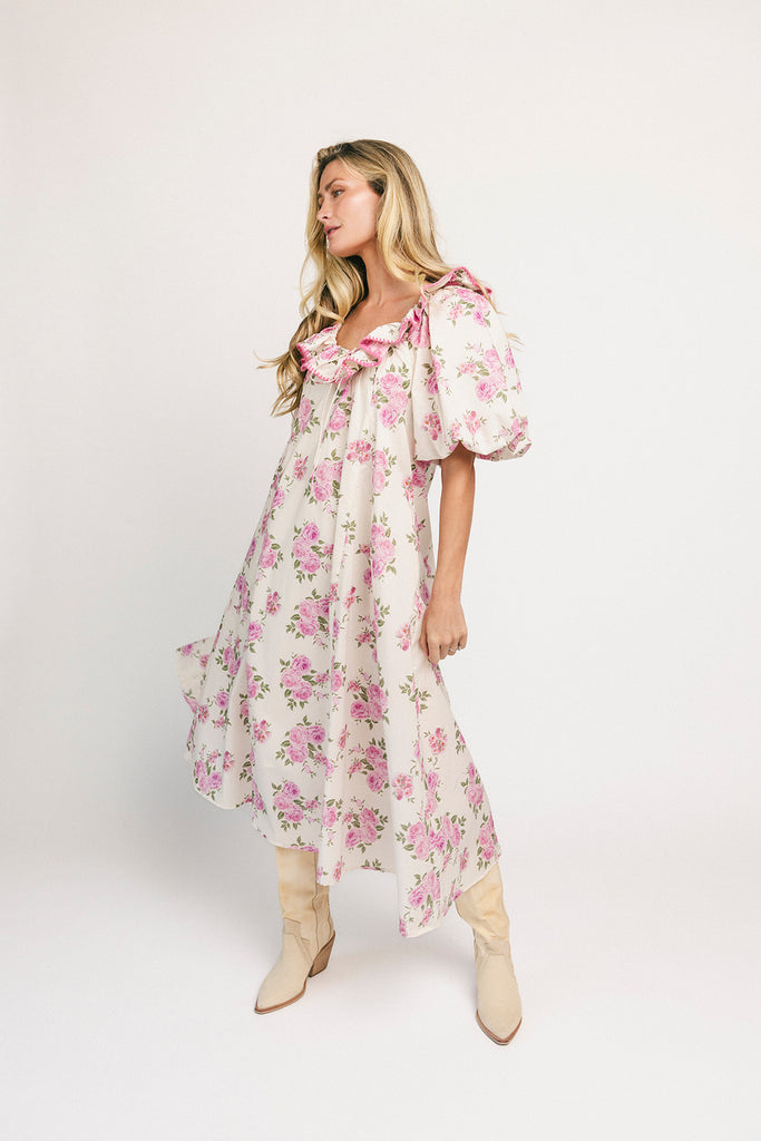 a pink floral puff sleeve dress with a ruffle neckline. the perfect vintage-inspired dress for baby showers, family pictures, + special occasions.
