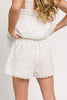 white cotton shorts with eyelet details. pair them with the matching white tank top to create the perfect two piece set for brunch dates, vacations, + everyday wear. 