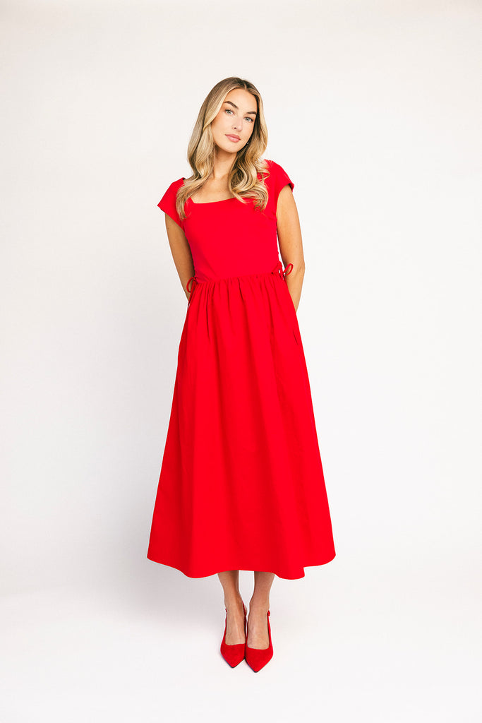 zoco afterglow dress: red short sleeve midi dress with a square neckline and side ties. perfect for date nights, weddings, and family pictures.
