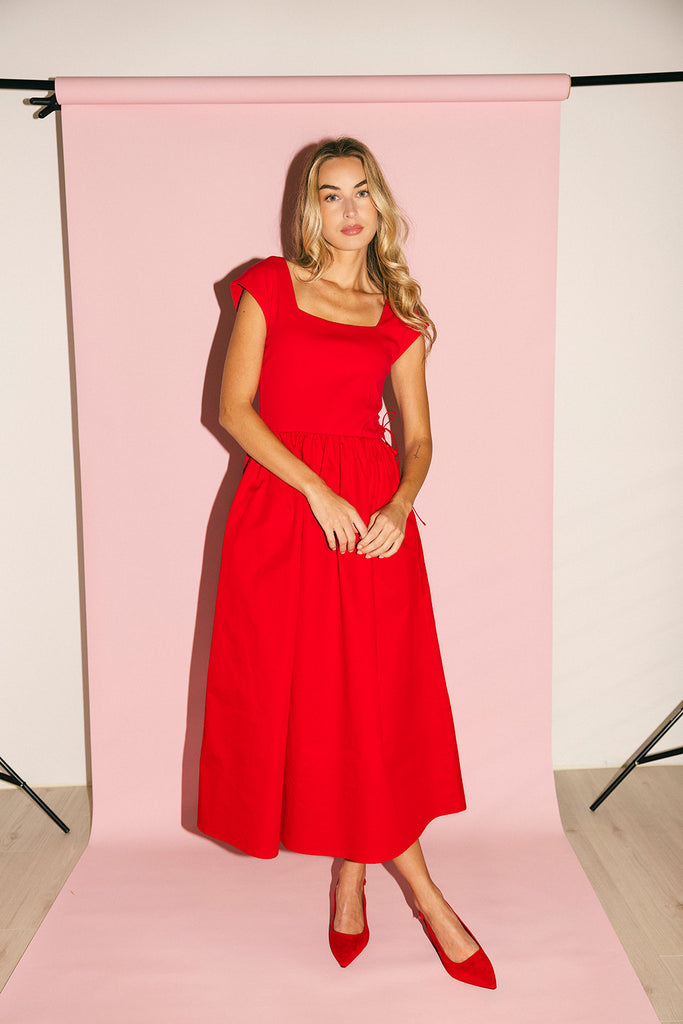 zoco afterglow dress: red short sleeve midi dress with a square neckline and side ties. perfect for date nights, weddings, and family pictures.
