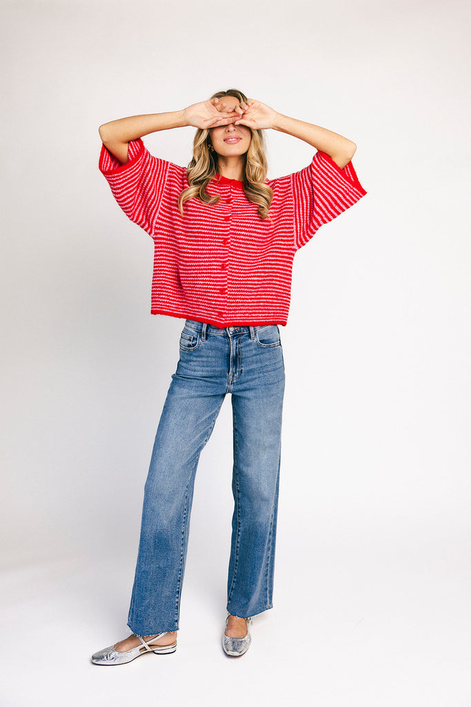 red and pink striped cardigan with short sleeves and a relaxed fit. perfect for casual outfits and lightweight layering. 

