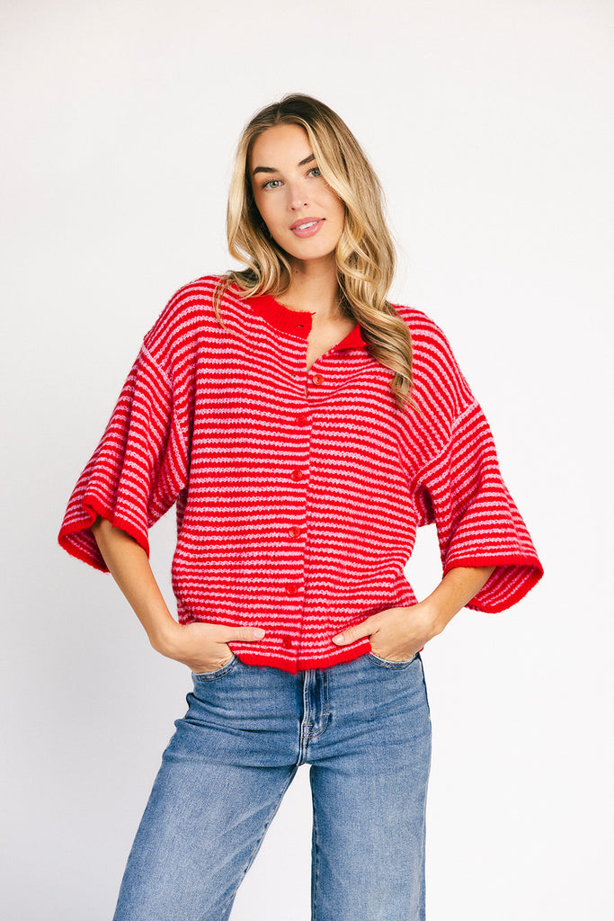red and pink striped cardigan with short sleeves and a relaxed fit. perfect for casual outfits and lightweight layering. 
