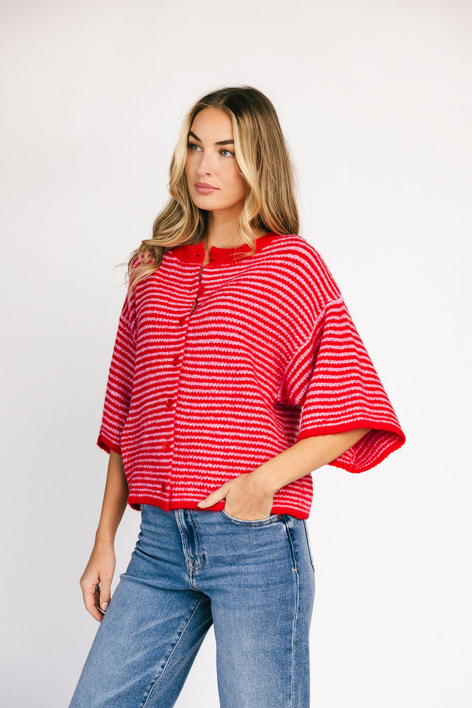 red and pink striped cardigan with short sleeves and a relaxed fit. perfect for casual outfits and lightweight layering. 
