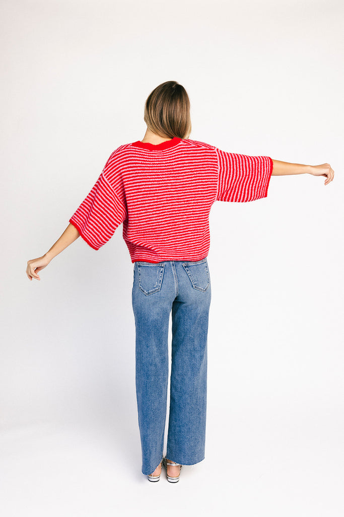 red and pink striped cardigan with short sleeves and a relaxed fit. perfect for casual outfits and lightweight layering. 

