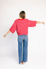 red and pink striped cardigan with short sleeves and a relaxed fit. perfect for casual outfits and lightweight layering. 
