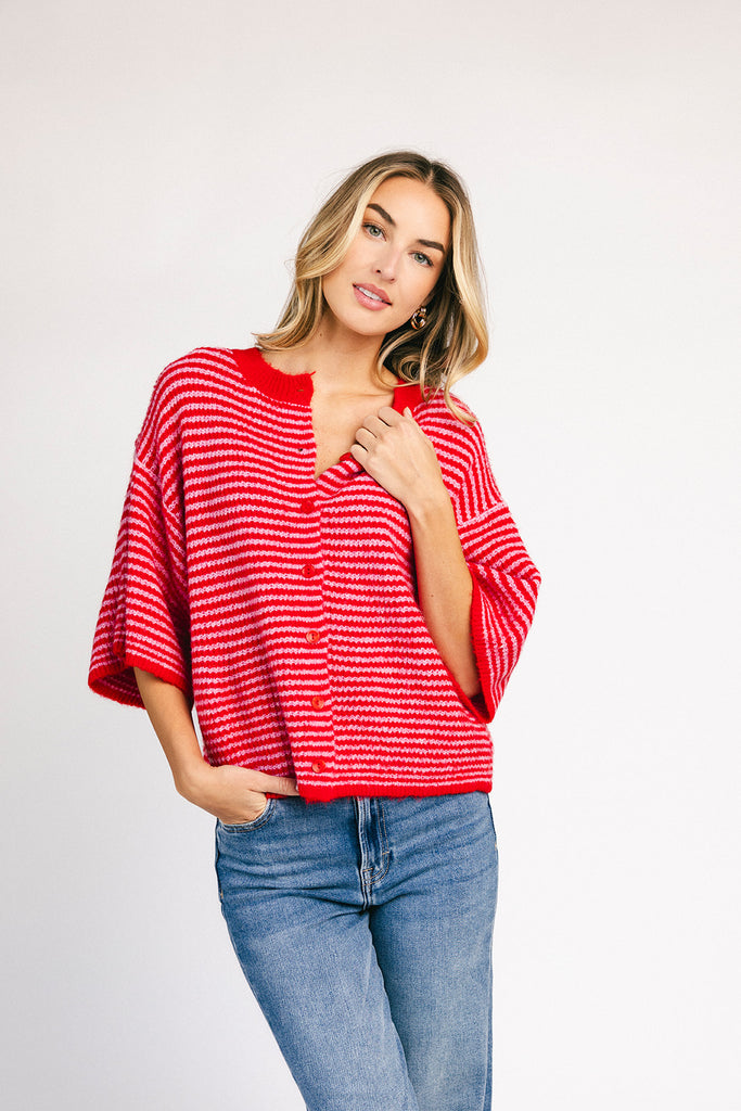 red and pink striped cardigan with short sleeves and a relaxed fit. perfect for casual outfits and lightweight layering. 
