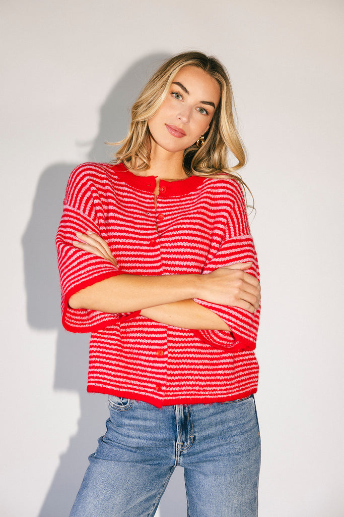 red and pink striped cardigan with short sleeves and a relaxed fit. perfect for casual outfits and lightweight layering. 
