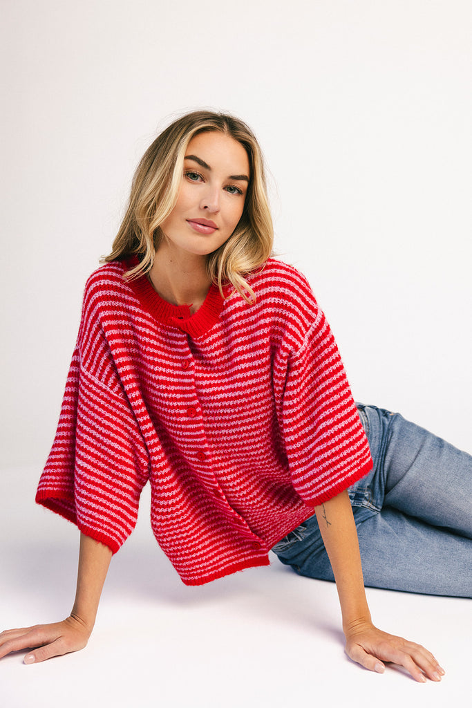 red and pink striped cardigan with short sleeves and a relaxed fit. perfect for casual outfits and lightweight layering. 
