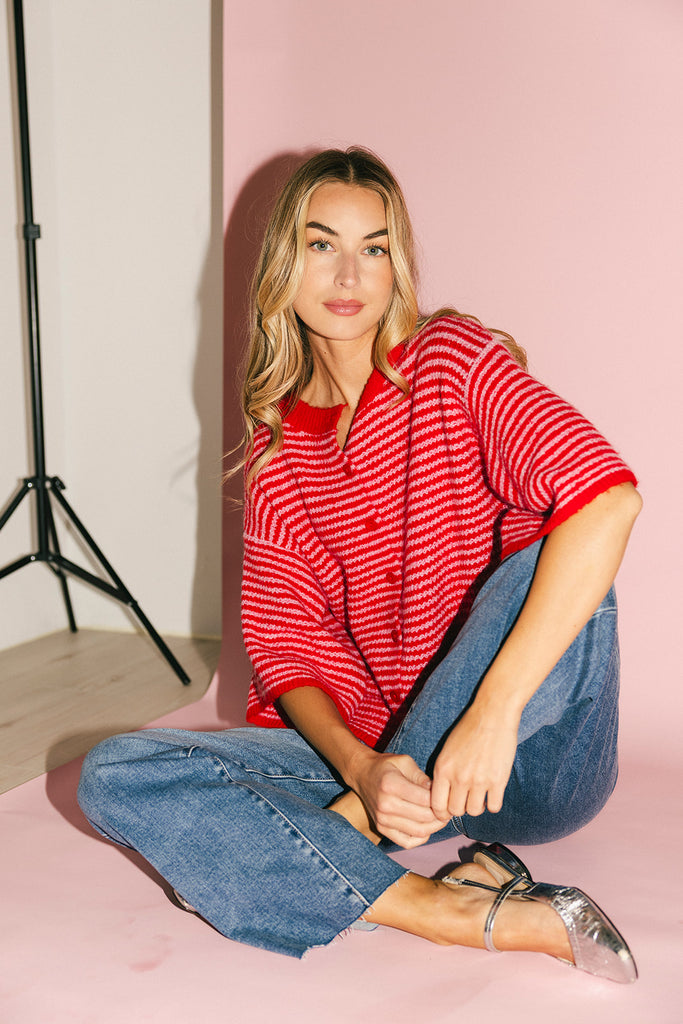 red and pink striped cardigan with short sleeves and a relaxed fit. perfect for casual outfits and lightweight layering. 
