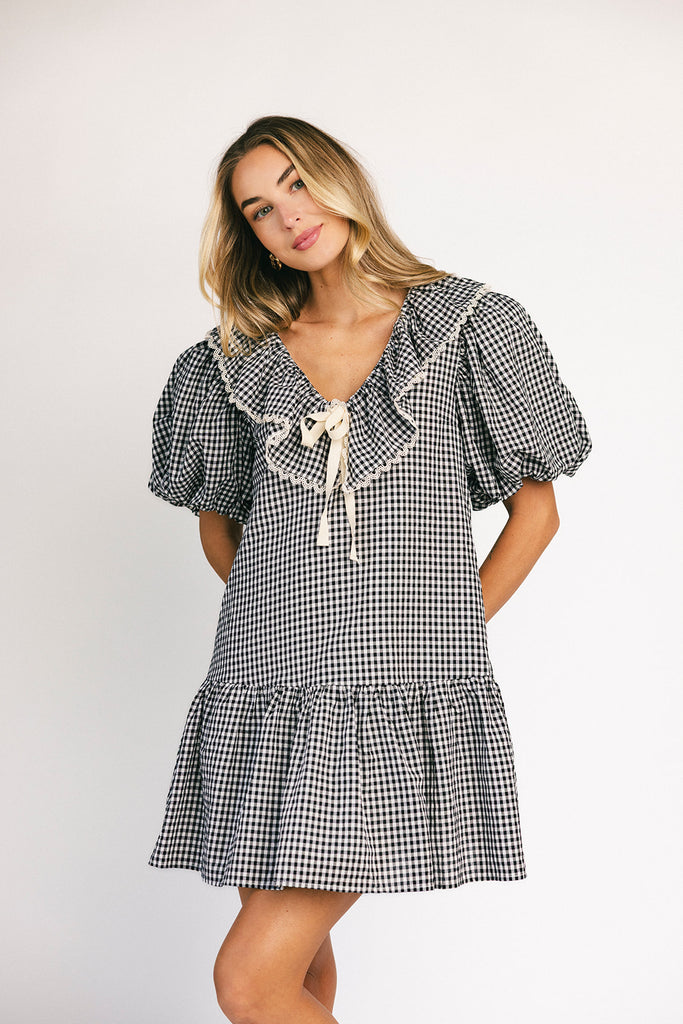 vintage inspired puff sleeve mini dress with a lace trim collar. the perfect black and white gingham mini dress for baby showers, bridal showers, and semi-formal occasions.
