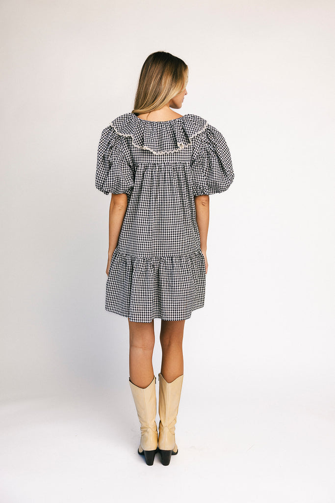 vintage inspired puff sleeve mini dress with a lace trim collar. the perfect black and white gingham mini dress for baby showers, bridal showers, and semi-formal occasions.

