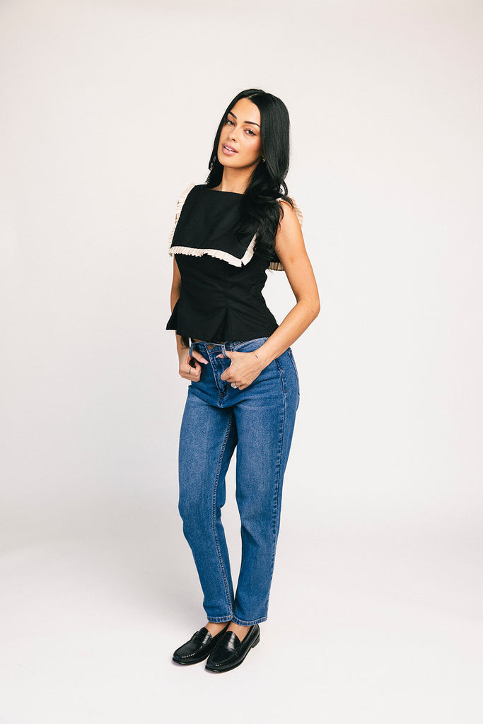 a vintage-inspired fitted tank with an oversized ruffle collar detail. the perfect elevated top for the office + dressy date nights. 