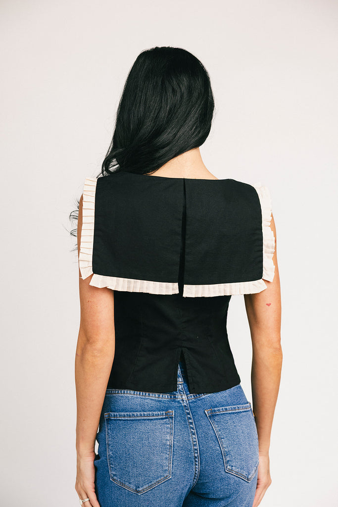 a vintage-inspired fitted tank with an oversized ruffle collar detail. the perfect elevated top for the office + dressy date nights. 