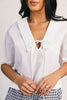 a vintage-inspired short sleeve white top with a relaxed fit + lace trim collar. the perfect elevated basic to dress up or down for any spring + summer outfit idea.