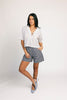 a vintage-inspired short sleeve white top with a relaxed fit + lace trim collar. the perfect elevated basic to dress up or down for any spring + summer outfit idea.