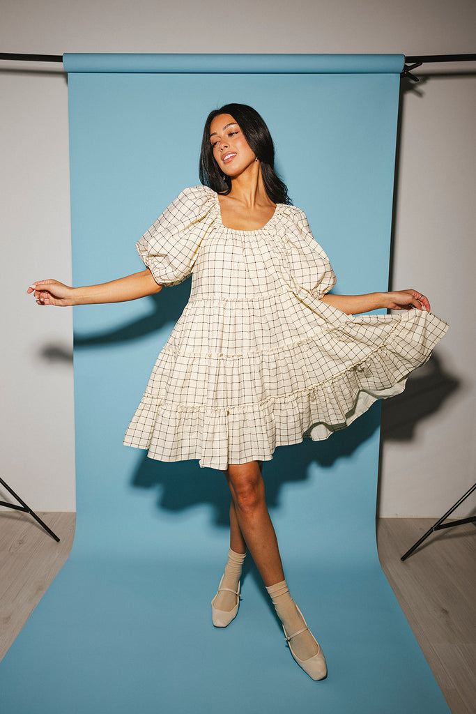 zoco daymaker dress: a short puff sleeve dress with a grid-style pattern + an elastic neckline. perfect for family pictures, weddings, and baby showers.
