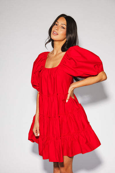 zoco daymaker dress: a short puff sleeve dress with an elastic neckline. the perfect red cotton dress for family pictures, weddings, and baby showers.

