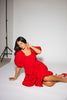 zoco daymaker dress: a short puff sleeve dress with an elastic neckline. the perfect red cotton dress for family pictures, weddings, and baby showers.
