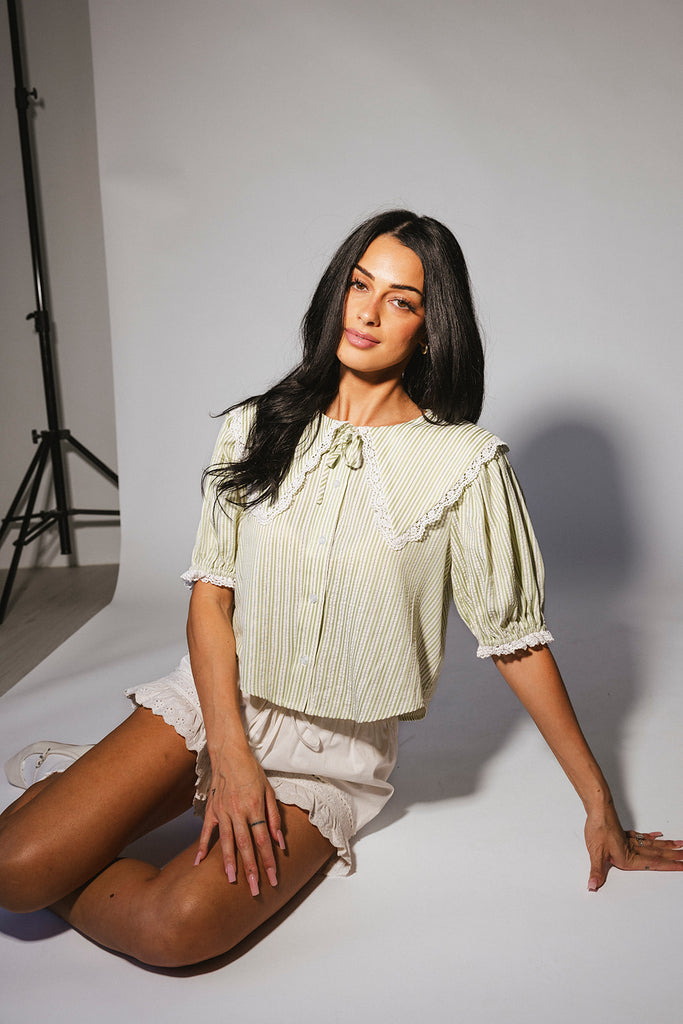 a vintage-inspired puff sleeve top with a pastel green pinstripe pattern + an oversized lace trim collar. the perfect elevated button up top for the office, dressy date nights, + everyday wear.
