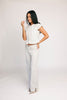 a white denim short sleeve top with a fitted silhouette + a peplum hemline. the perfect denim top to dress up or down for any outfit idea.
