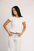 a white denim short sleeve top with a fitted silhouette + a peplum hemline. the perfect denim top to dress up or down for any outfit idea.
