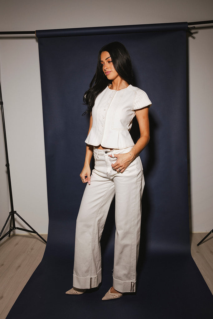 a white denim short sleeve top with a fitted silhouette + a peplum hemline. the perfect denim top to dress up or down for any outfit idea.
