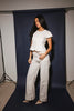 a white denim short sleeve top with a fitted silhouette + a peplum hemline. the perfect denim top to dress up or down for any outfit idea.
