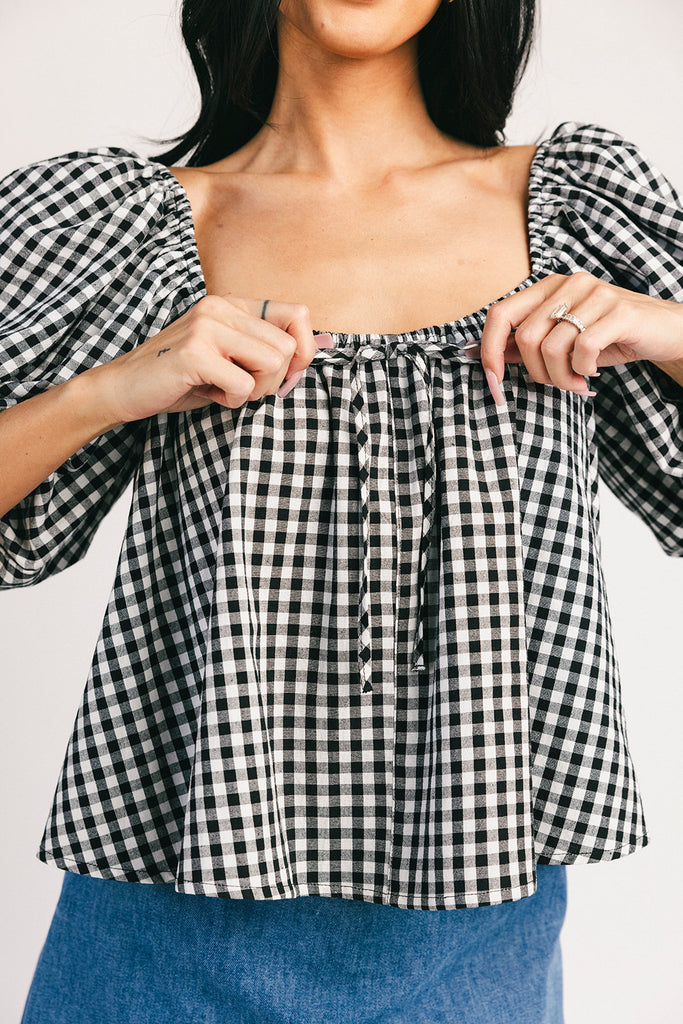 black and white gingham puff sleeve top with an elastic neckline + bow detail. the perfect elevated basic top for date nights + casual outfits. 