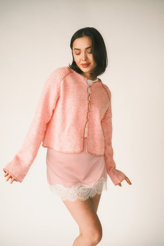 vintage inspired pink cardigan with toggle buttons and an open front. perfect for casual outfits and lightweight layering. 
