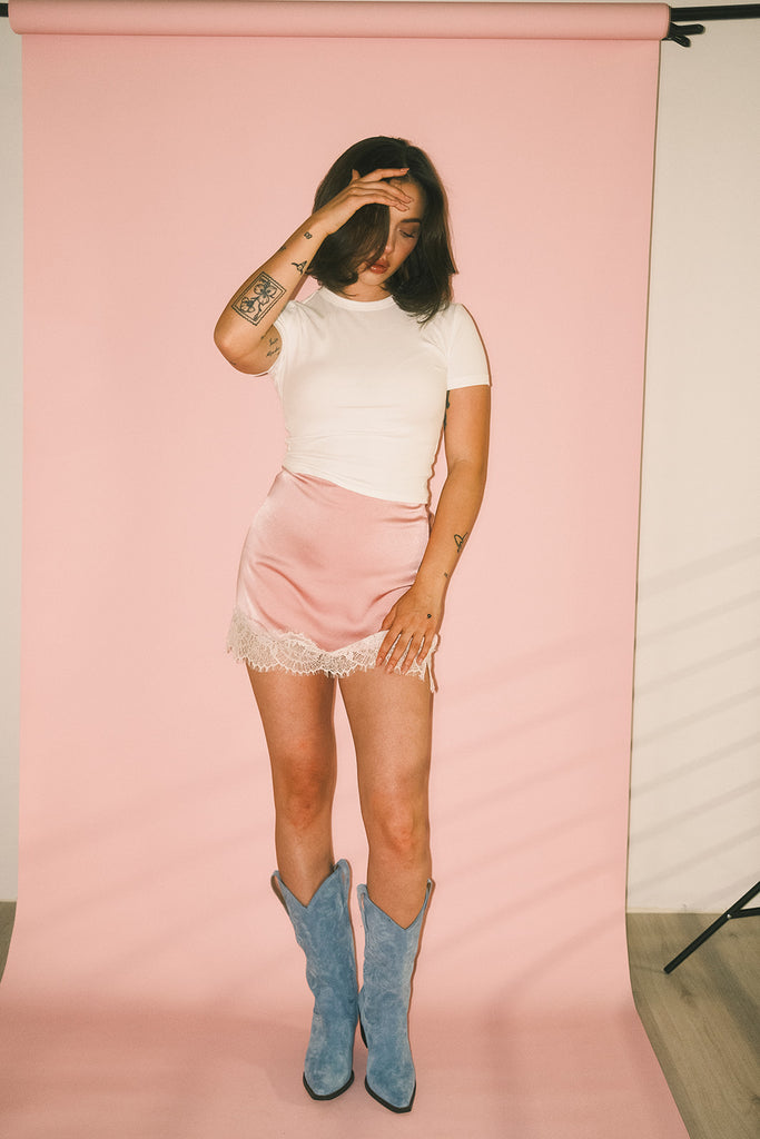 pink satin mini skirt with lace trim. perfect for date night outfits, semi formal outfits, and everyday wear.
